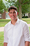 Matthew Capuano standing outside wearing a white shirt
